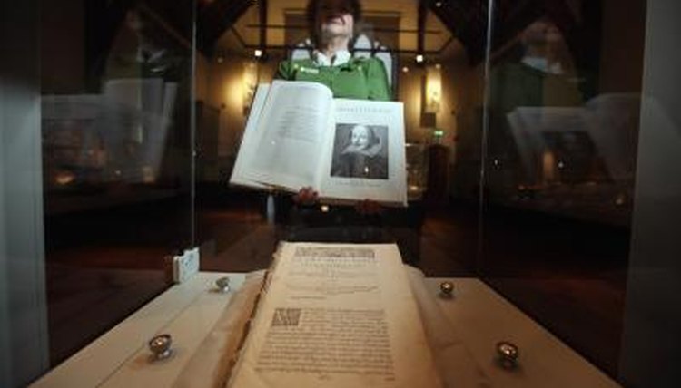 The head of collections at Durham University Library holding a book from the Shakespeare exhibit.