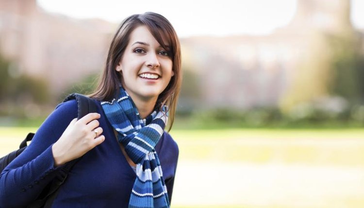 College student putting on backpack