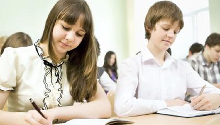 Students writing in notebooks.