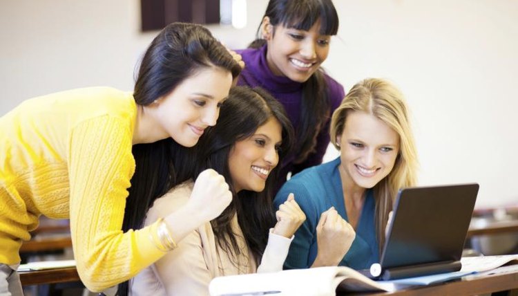 Students working on business project in classroom