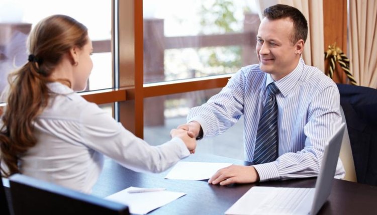 Woman shaking hand of businessman