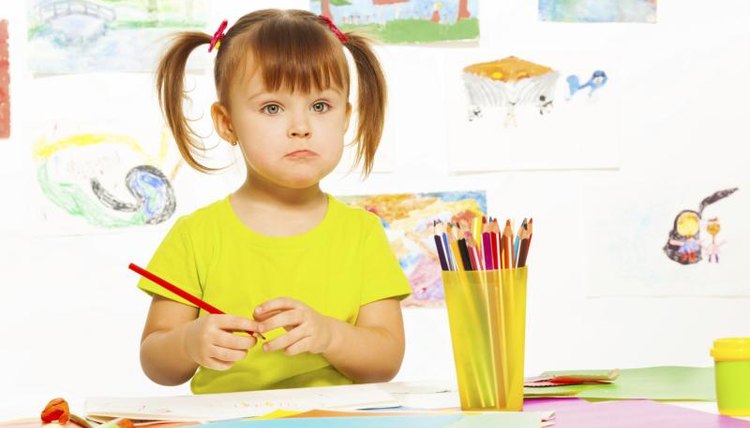 A child drawing a picture at school.