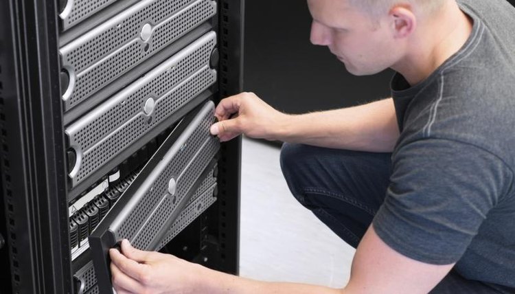 A technician works on a server mainframe.