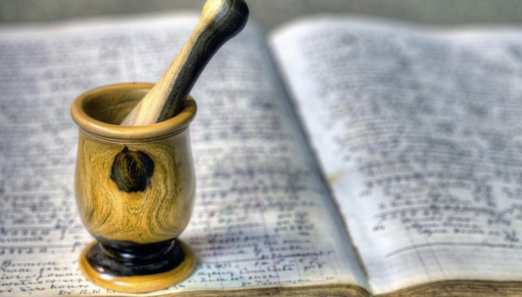 Old pharmacopeias with mortar and pestle