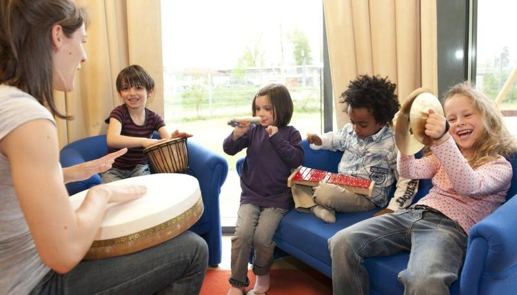 Teacher and students making music.