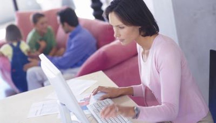 Woman studies with family in background