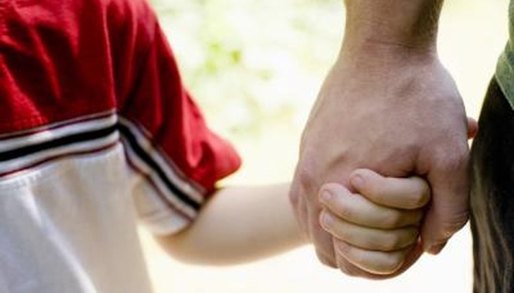 Father holding son's hand