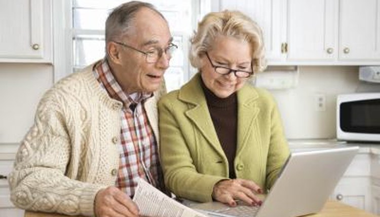 Senior couple working on a laptop.