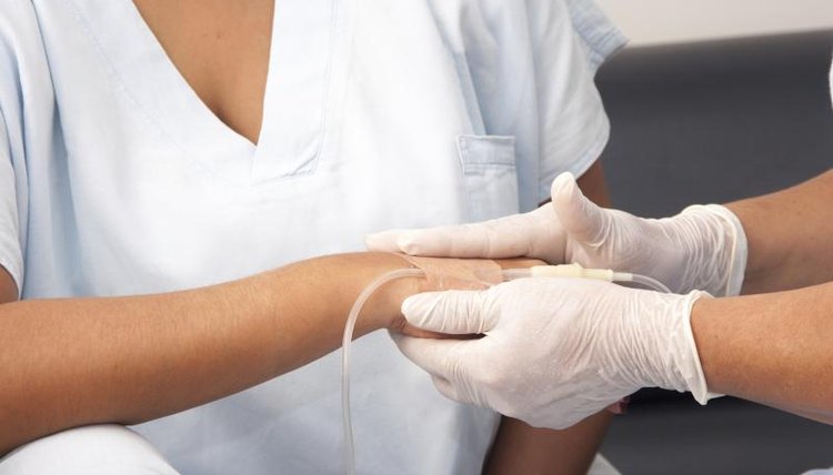 A doctor is administering an IV.
