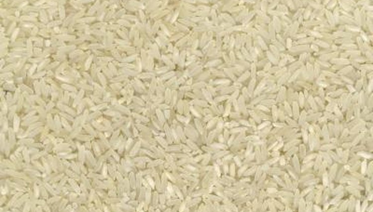 Use measuring cups to fill storage containers with rice.
