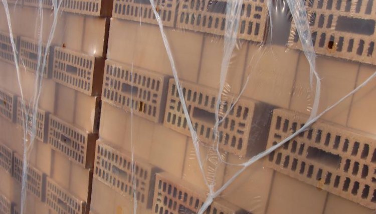 Stacks of bricks wrapped in plastic sheeting