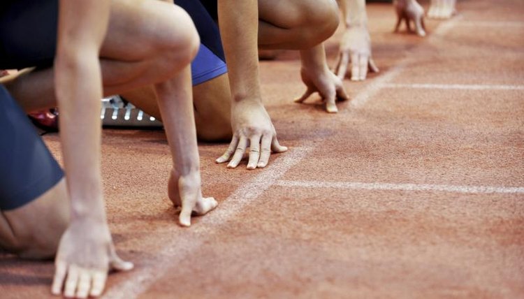 Close-up of runners lined up on track