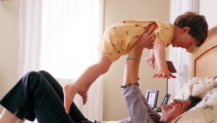 Mom playing with son in bedroom