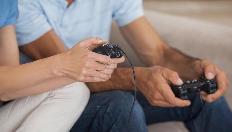 Close-up of friends playing video game