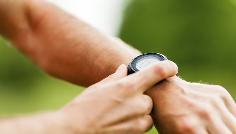 Trail runner looking at sport watch