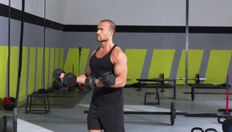 Gym man with dumbbells exercise crossfit