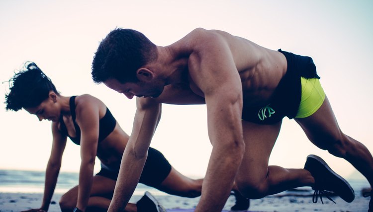 couple works out on the beach