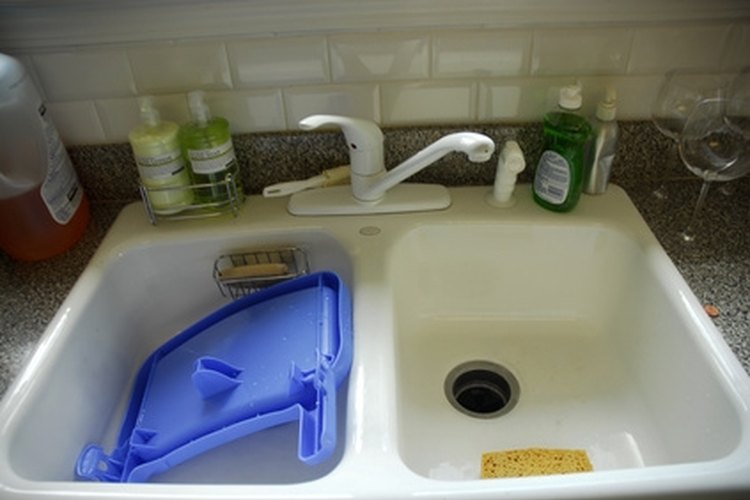 kitchen sink image by jedphoto from Fotolia.com Fiberglass is a common material used to make sinks.