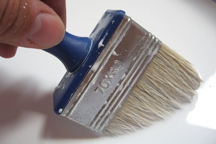 brush in paint image by Vladislav Gajic from Fotolia.com Painting your laminate flooring is one way to prolong its life.