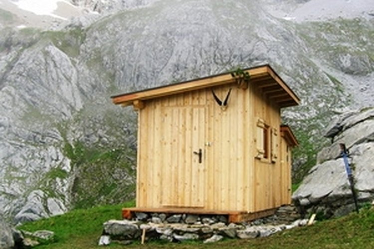 mountains behind a hut image by martin schmid from Fotolia.com A shooting house can protect you from the elements and increase your chances of a successful hunt.