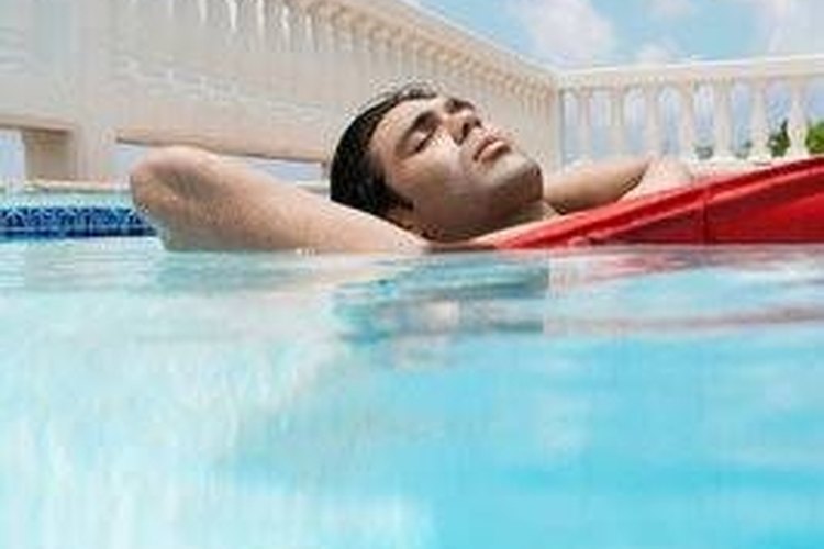 inmagine.com Young man on raft in pool.