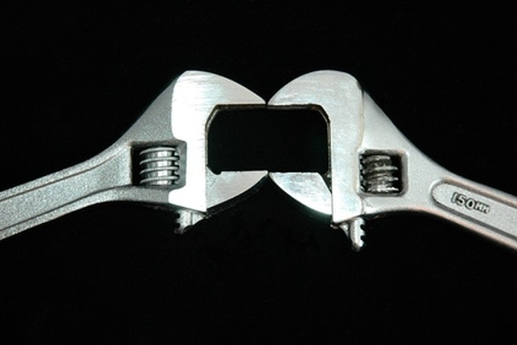 wrench jaws image by Warren Millar from Fotolia.com It takes two wrenches to remove hand-cranked winch bolts.