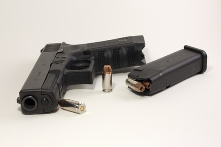 ready to load image by John Steel from Fotolia.com A Glock 9mm with bullets and magazine.
