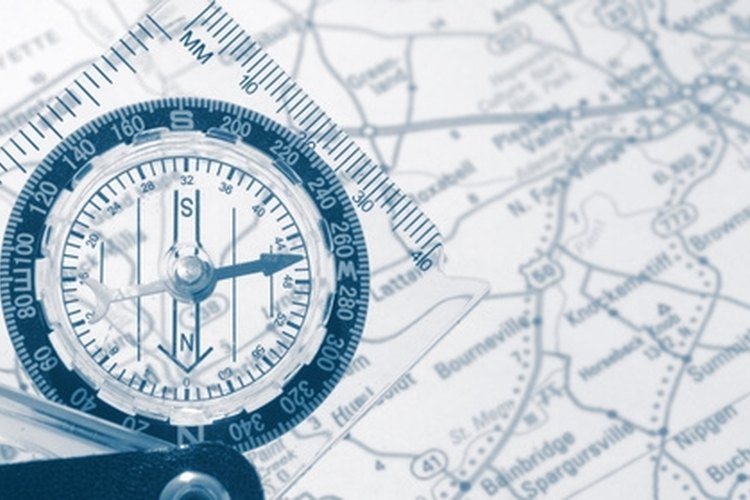 compass with map image by Paul Hill from Fotolia.com Using a compass like Suunto aids in improving navigational capabilities.