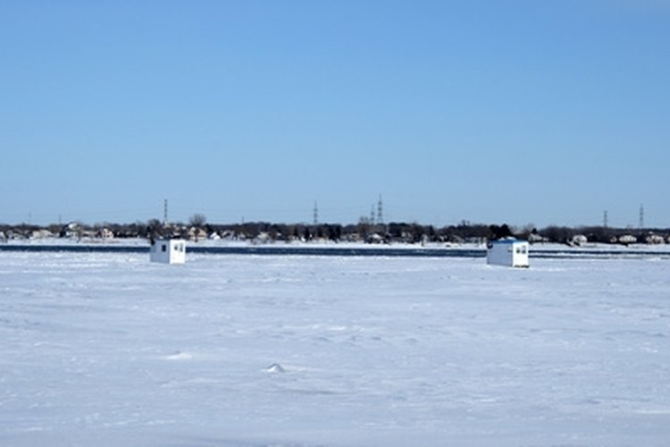 ice fishing huts on a frozen river image by GoodMood Photo from Fotolia.com Spearhouses are used as shelter while fishermen fish through the ice.