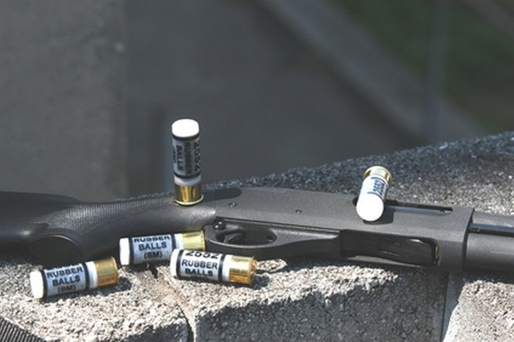 less lethal shotgun and shells. image by Kevin Chesson from Fotolia.com Pump action shotgun