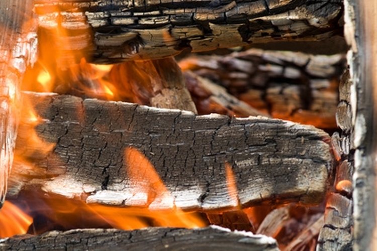 campfire full of burning wood for preparation of the shish kebab image by Irina Igumnova from Fotolia.com Choose the right wood and build your fire carefully.