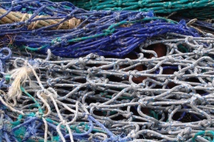 coloured fishing nets image by Joe Houghton from Fotolia.com Knot your own fishing nets.