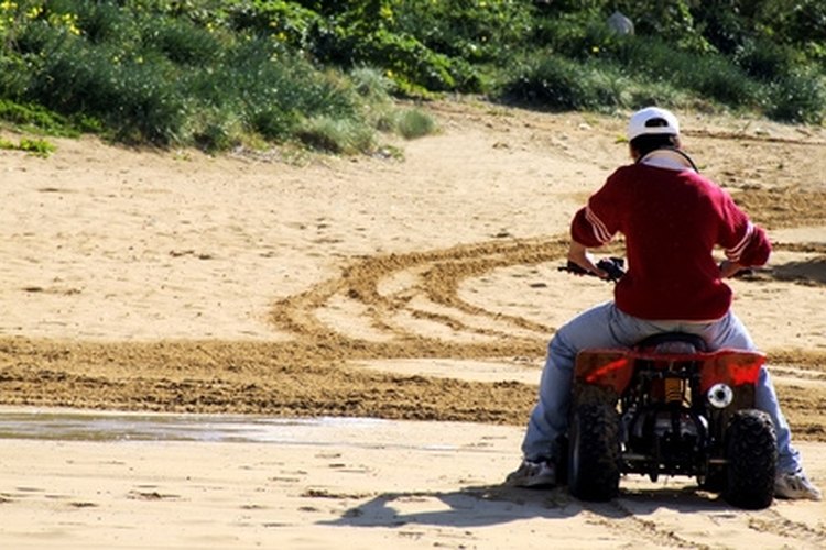 quad bike image by FotoWorx from Fotolia.com Approaching a curve on an automatic four-wheeler, slow down by reducing the throttle.