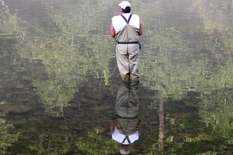 Foggy Morning Flyfishing image by Joyce Wilkes from Fotolia.com Waders keep you dry while fly fishing.