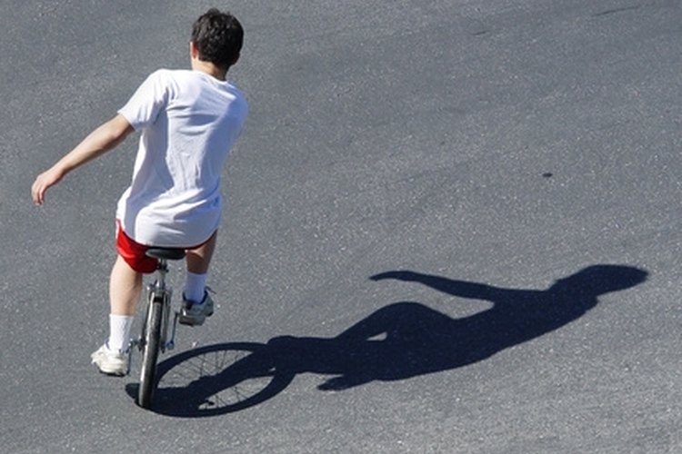 boy balancing on a unicycle image by Galina Barskaya from Fotolia.com A unicycle requires great balance to ride.