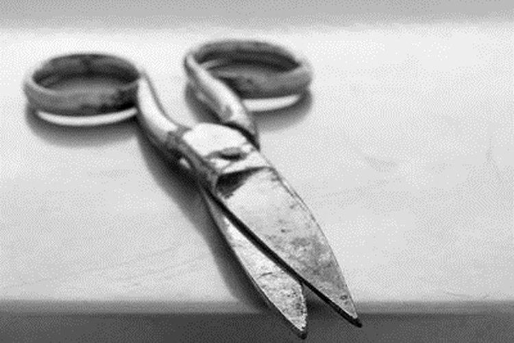 scissors image by Pefkos from Fotolia.com A few tools will help in mending a fishing net.