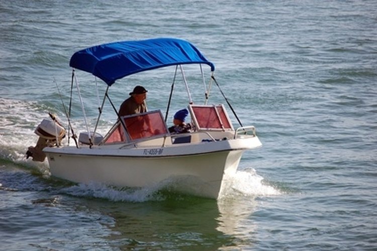 outboard motor boat image by Wimbledon from Fotolia.com Outboard motors must be cleaned and maintained regularly to provide reliable power.
