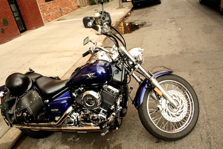 motorcycle image by Bionic Media from Fotolia.com Turning the front tire into the lean prevents the bike from falling.
