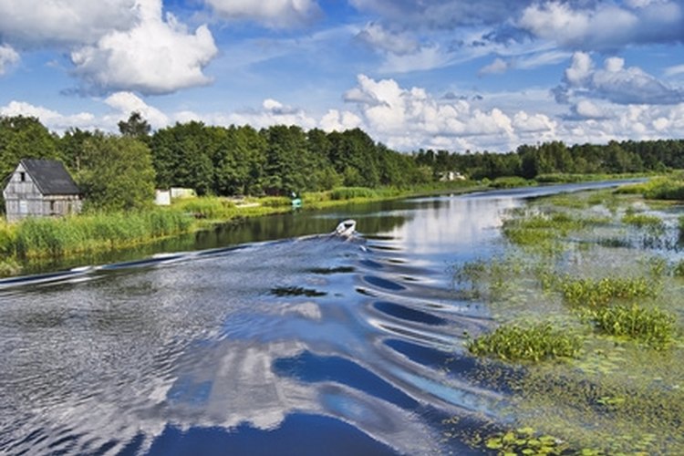 Motor boat on the river with reflection of the sky image by Annavale from Fotolia.com Boating with an Elto outboard motor