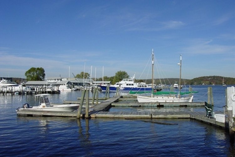 dock image by Chris Roselli from Fotolia.com Place a box step at the end of a floating dock to minimize wear and tear.