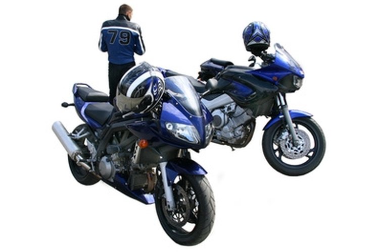 two motorcycles. image by Yuri Bizgaimer from Fotolia.com Dollies are used to maneuver a motorcycle in the garage or shop.