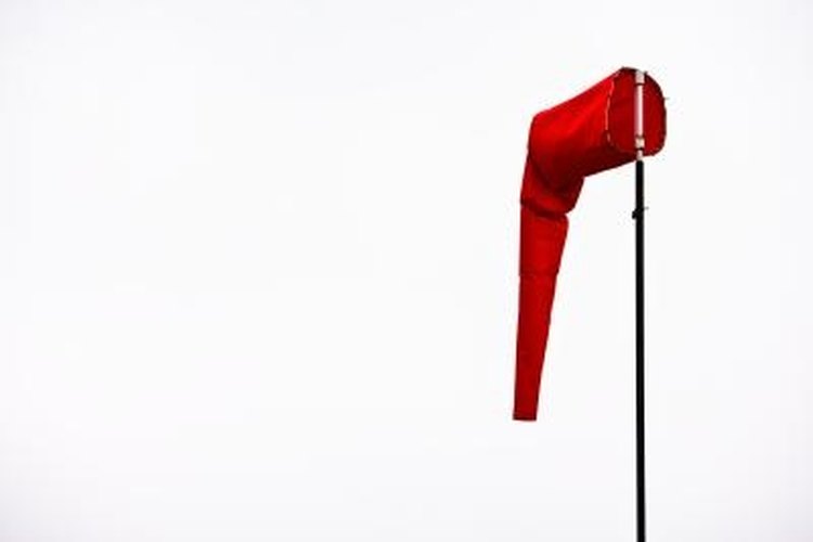 Jupiterimages/Photos.com/Getty Images A wind sock is one useful way of determining wind direction as well as a rough speed estimate.