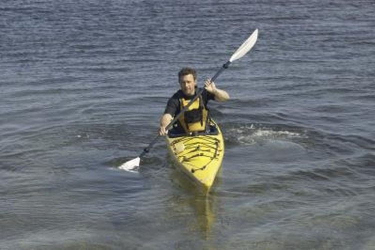 Hemera Technologies/AbleStock.com/Getty Images Paddle stroke technique is one method of improving the tracking of a kayak.