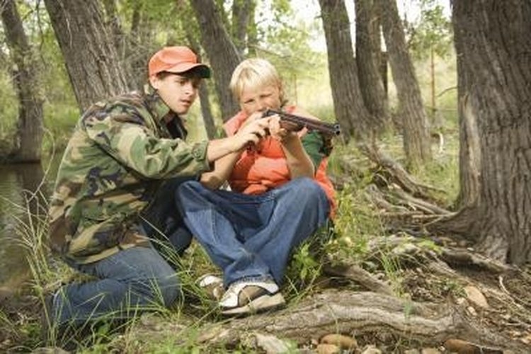 Jupiterimages/Comstock/Getty Images The light recoil of a .22 caliber rifle provides a starting point for young shooters.