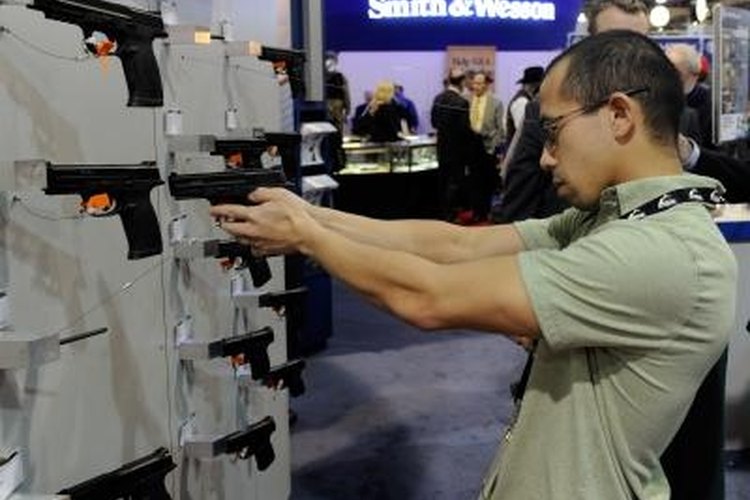 Ethan Miller/Getty Images News/Getty Images Both state and federal records are checked when purchasing a firearm.