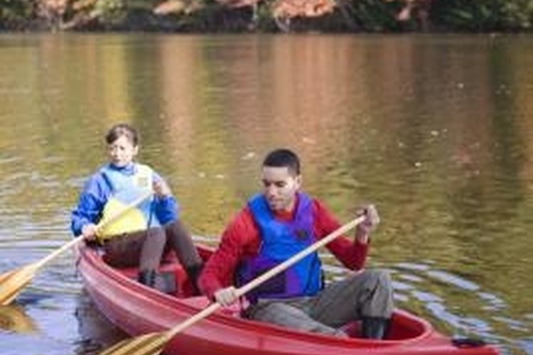 Jupiterimages/Brand X Pictures/Getty Images Canoes come in single, double and triple passenger form.