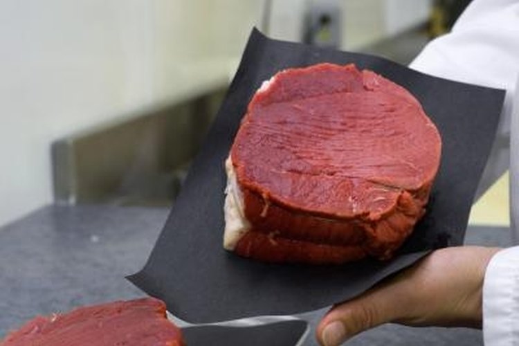 Jupiterimages/Photos.com/Getty Images Always cut with the grain of the meat or it will cook tough.