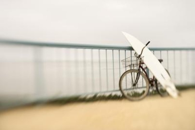 Thinkstock/Comstock/Getty Images A crack in a surfboard can be a result of its transportation to the beach.