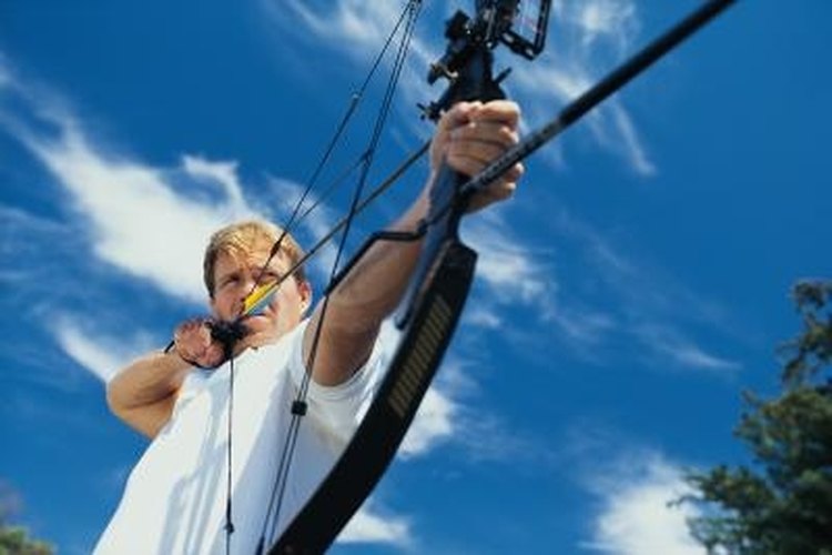 Comstock/Comstock/Getty Images Bow peep sights attach to the string this man is pulling.