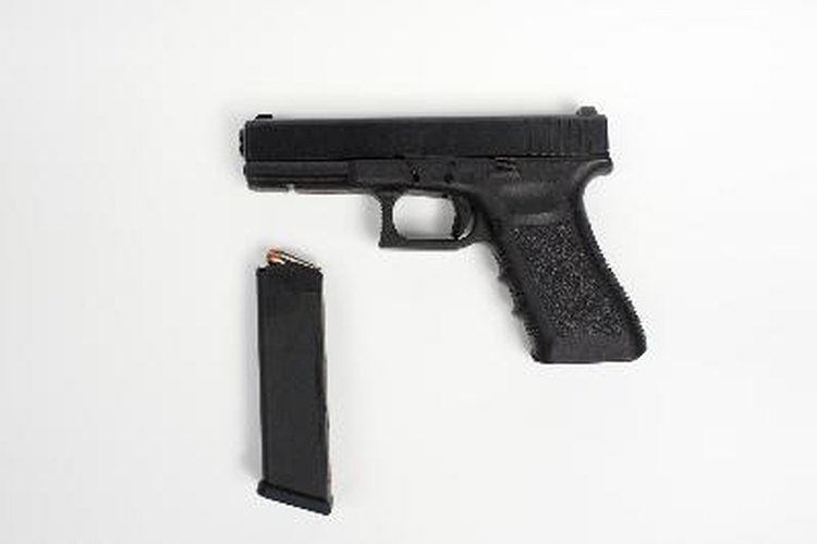 handgun with clip on white background image by John Steel from Fotolia.com